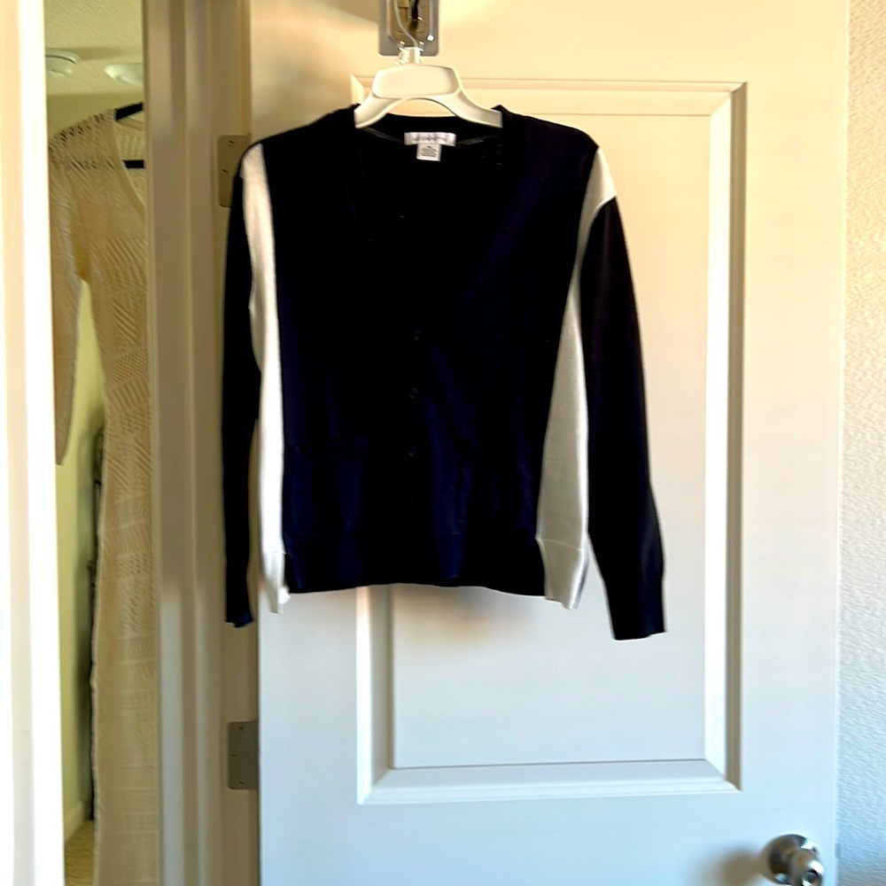 New without tags. Multiple color sweater. Black, navy, and white